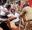 Police taking away a CPM activist who was protesting against price rise in Mangalore on Thursday. DH photo