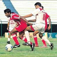 KEEN TUSSLE: SBTs Mohammed Harris (right) tackles Firoz K of Malabar United in the                        I-League II Division match at the Bangalore Football stadium on Monday. DH PHOTO