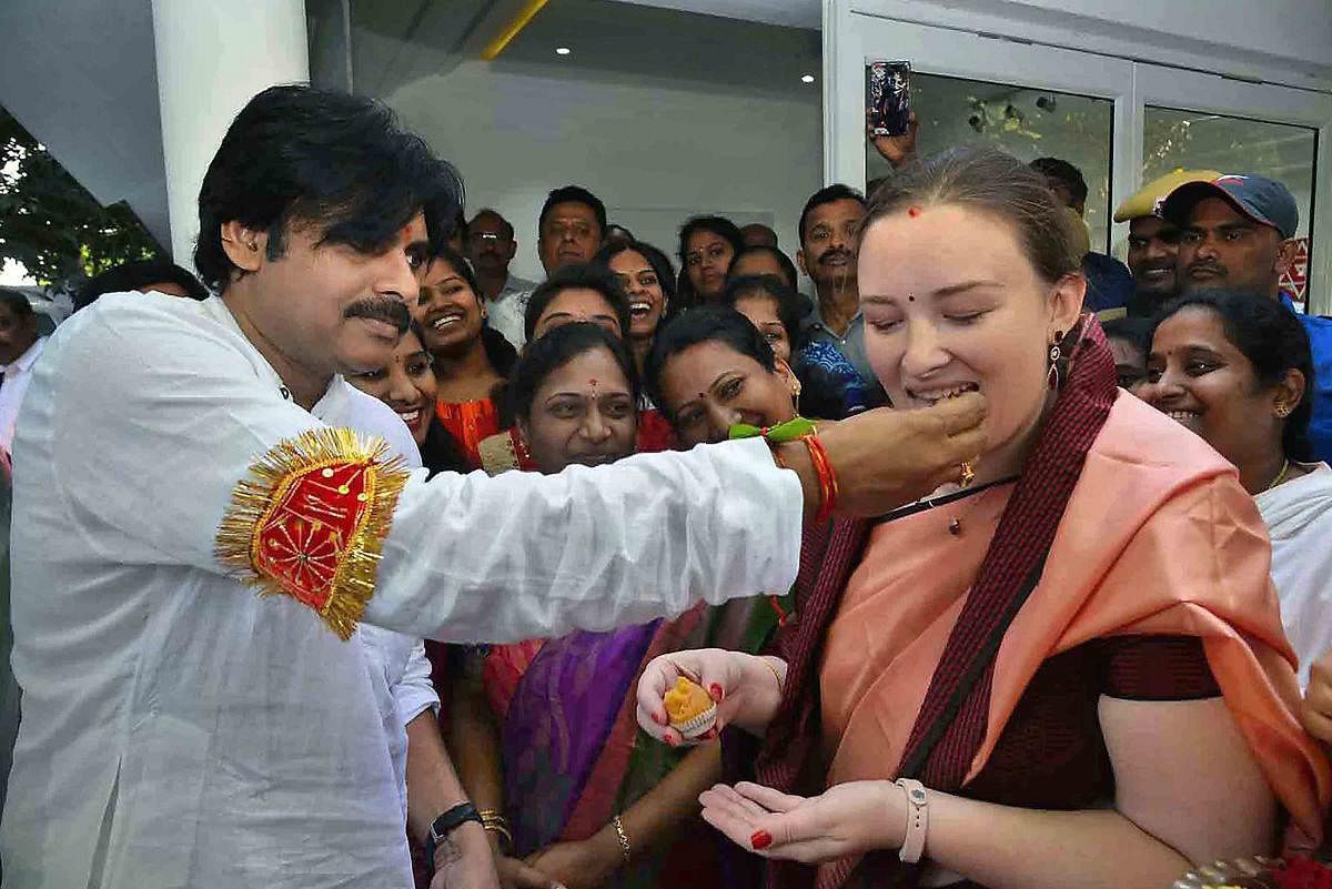Jana Sena Party chief and actor Pawan Kalyan offers sweets to his wife Anna Lezhneva before leaving for Kondagattu to launch his 'Chalo re Chalo' yatra (political tour) in in Hyderabad on Monday. PTI