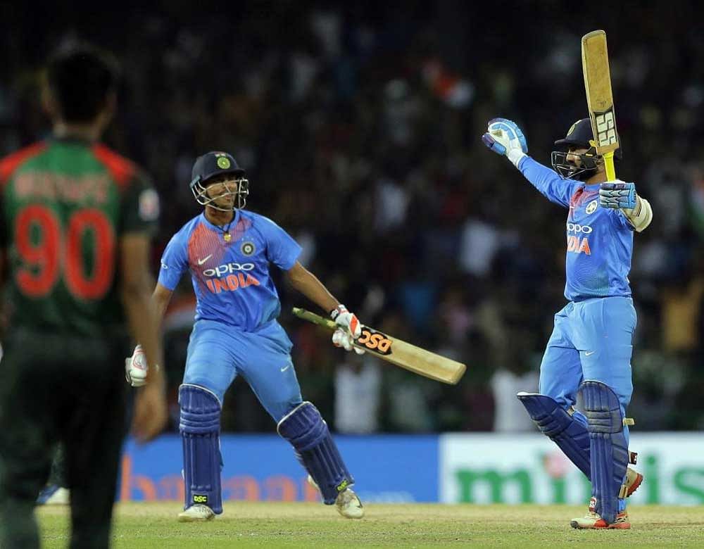 Dinesh Karthik, right, celebrates scoring the winning run to defeat Bangladesh by four wickets during the finals of Nidahas triangular Twenty20 cricket series in Colombo. AP/PTI
