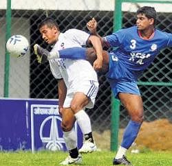 Its mine!: Oil Indias Manas Manjit Chetia (left) and SESAs Augustin Fernandes vie for the ball in their I-League Second Division match in Bangalore on Saturday. DH Photo