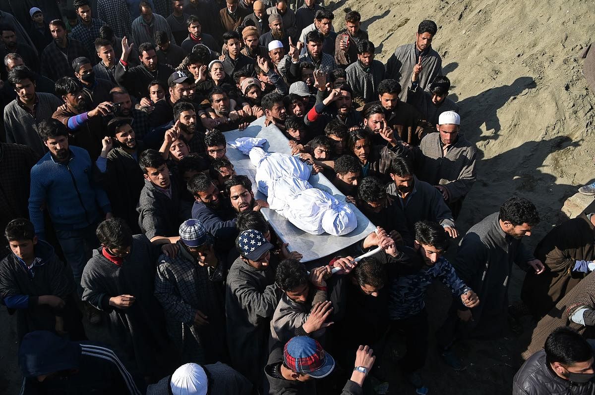 Kashmiri villagers carry a charred body of a twelve-year-old boy, Aatif Mir, during a funeral procession in Hajin area, in Bandipora district of Kashmir. AFP