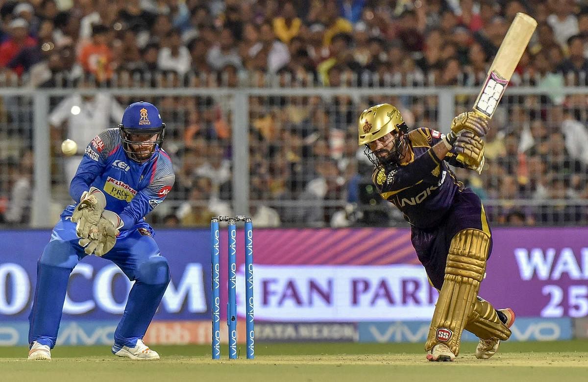Kolkata Knight Riders' captain Dinesh Karthik drives one to the fence en route to his 52. PTI