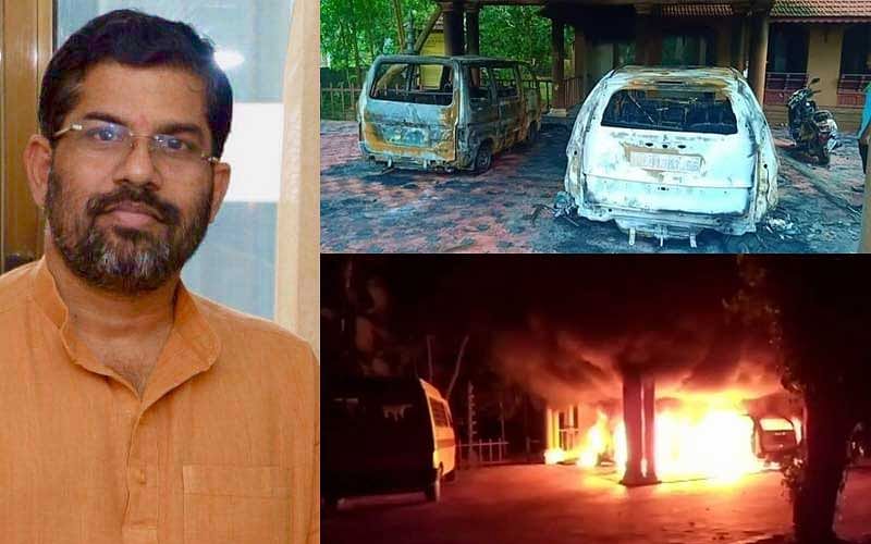 Swami Sandeepananda Giri and the charred vehicles in front of the ashram. (Courtesy: Facebook)