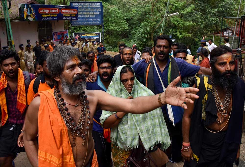 Padmavathi(48) from Eluru, Andrapradesh, try to visits Shabarimale Ayyappa temple with A group of pilgrims, she force to return by some of the devotees are protested about her age issue, at Neelamala on the trucking path, at Shabarimale, on Monday in Kerala. DH Photo/ B H Shivakumar