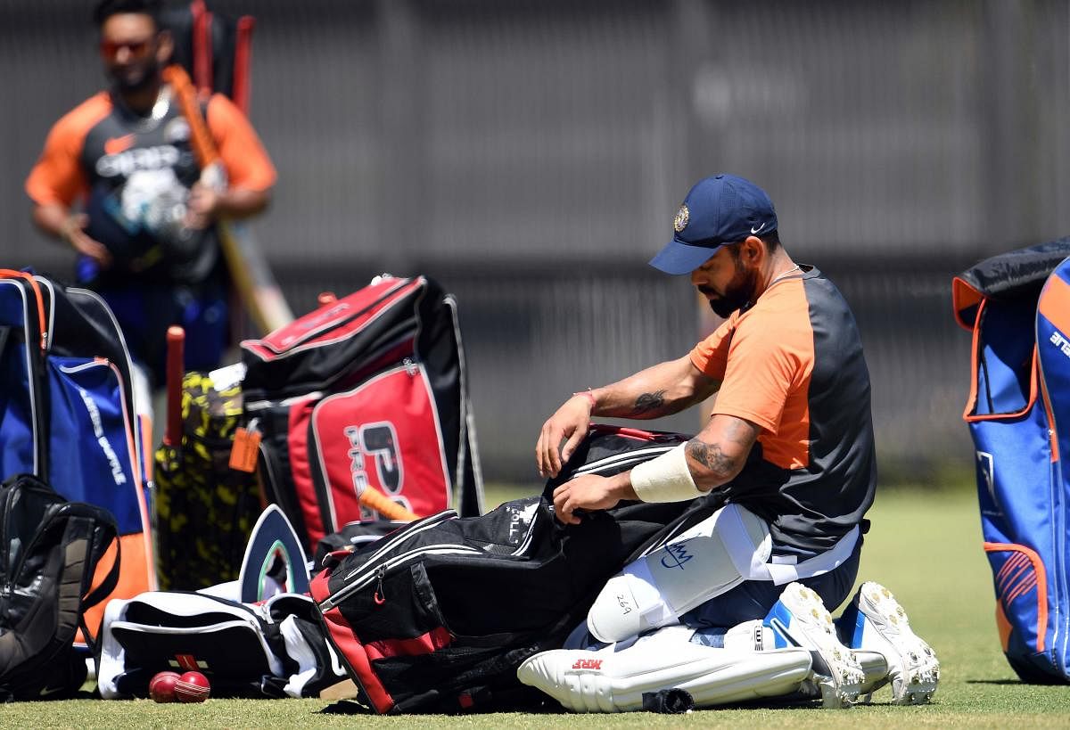 India's captain Virat Kohli packs up his cricket kit during a training session in Perth on December 13, 2018. (Photo by WILLIAM WEST / AFP)