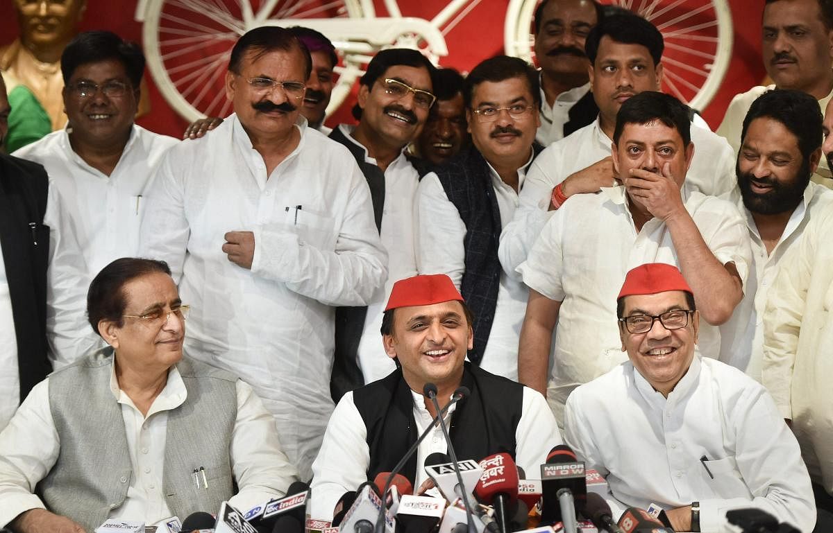 Samajwadi Party president Akhilesh Yadav, with senior leaders Kiranmoy Nanda and Azam Khan, addresses a press conference after the byelection results, at the party headquarters in Lucknow on Wednesday. PTI
