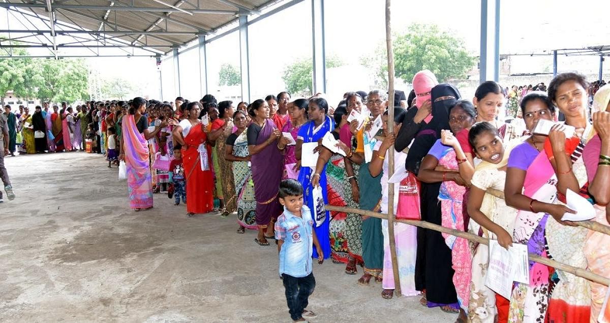 A file photo of people waiting to collect sarees from TRS leaders as part of the Bathukamma saree scheme in 2017.