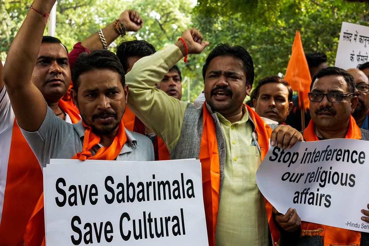 Members of the Hindu Sena shout slogans as they protest against the Supreme Court decision to allow women of all ages to enter inside the Sabarimala temple, in New Delhi on Thursday. AFP