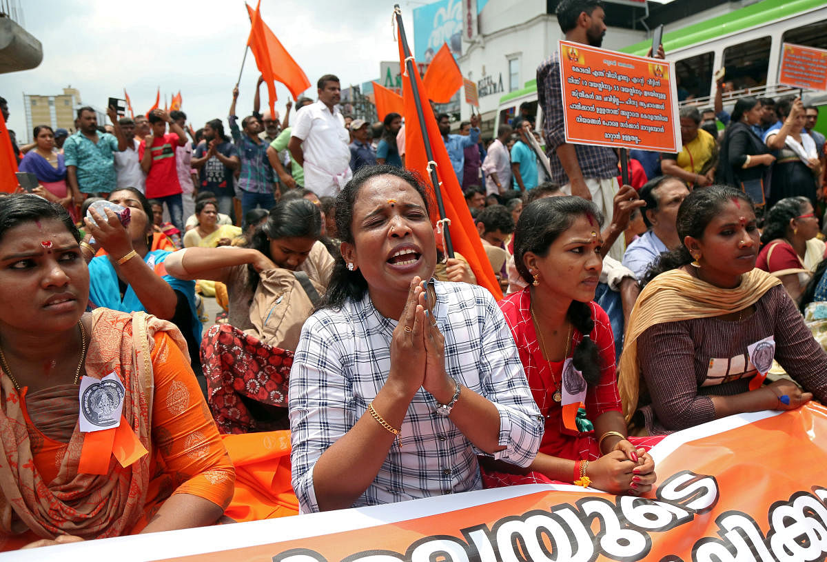A woman chants hymns during a protest called by various Hindu organisations against the Supreme Court's decision to allow entry of women of menstruating age into the Sabarimala temple, in Kochi. REUTERS
