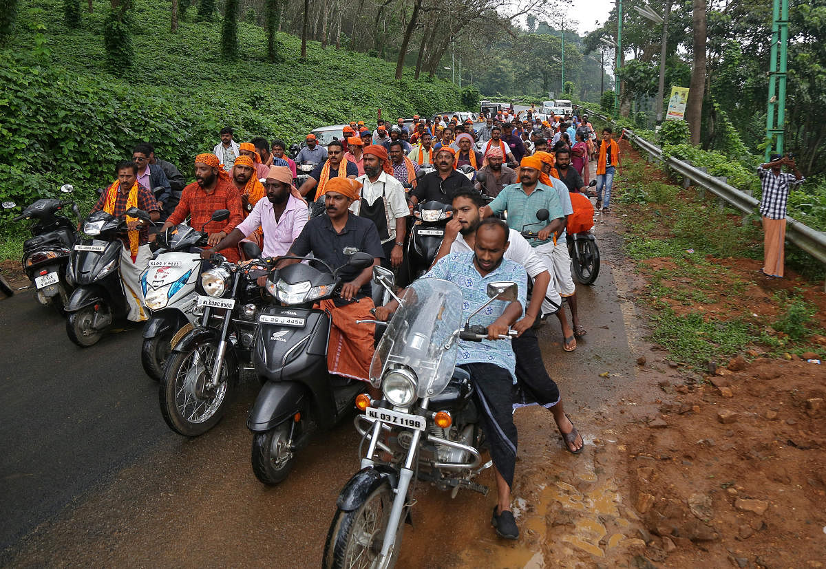 Hindu devotees take part in a motorcycle rally as part of a protest against the lifting of ban by Supreme Court that allowed entry of women of menstruating age to the Sabarimala temple, at Nilakkal Base camp in Pathanamthitta district in the southern stat