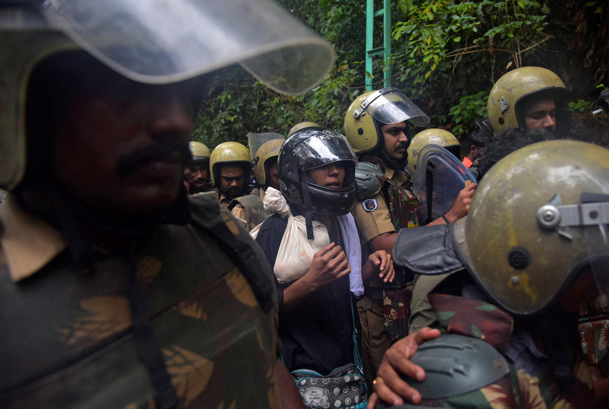 Police officers escort Rehana Fathima (C), who made an attempt to enter Sabarimala temple which traditionally bars the entry of women of menstrual age in Pathanamthitta. Reuters photo