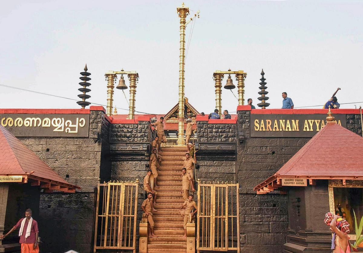 Police personnel stand guard at the 18 sacred steps of the Lord Ayyappa temple on the second day of Malayalam month of 'Vrischikam,' in Sabarimala, on Sunday. A few number of devotees were witnessed at the temple despite the day being a holiday (Sunday).