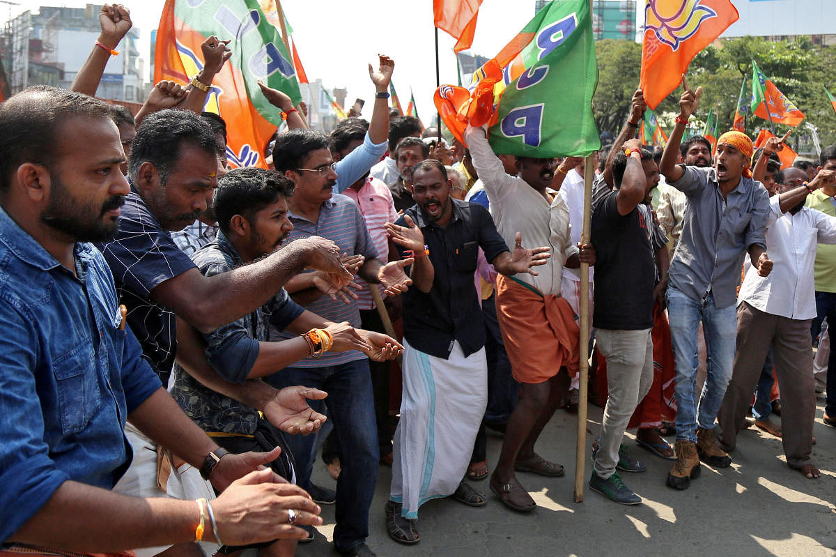 Supporters Bharatiya Janata Party (BJP) shout slogans as they block a highway during a protest against the arrest of their leader K Surendran, who police said was taken into preventive custody on Saturday night at Nilakkal base camp near the Sabarimala te