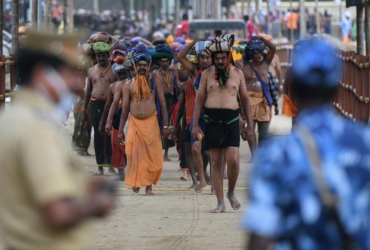 Police standing guard as devotees trek to the Sabarimala temple in Kerala. AFP