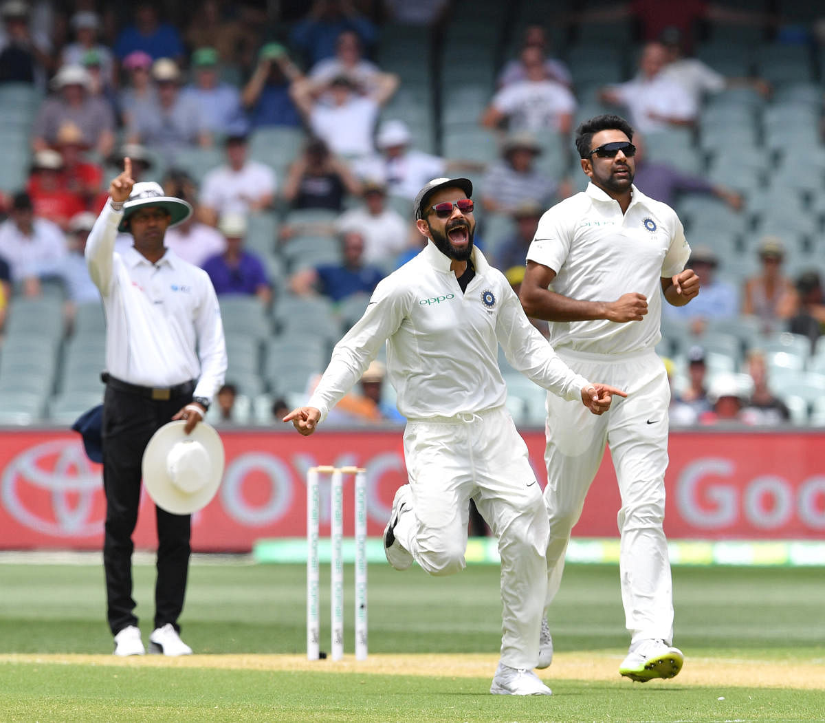 India's R Ashwin (right) and Virat Kohli celebrate the dismissal of Australia's Marcus Harris on Friday. REUTERS 