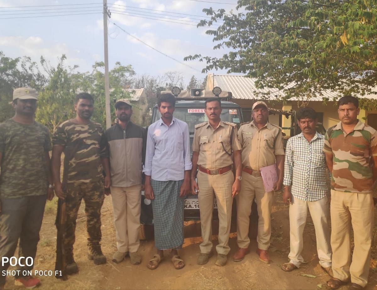 Forest department personnel with the accused, Arun Kumar, at Bandipur, on Thursday.