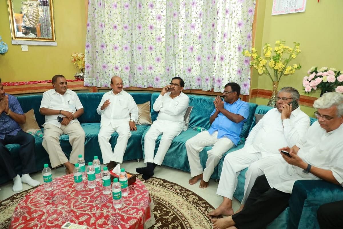 Deputy Chief Minister G Parameshwara holds meeting with Congress and JD(S) leaders at his residence in Tumakuru on Sunday. Small-Scale Industries Minister S R Srinivas, Congress leaders T B Jayachandra, E Radhakrishna among others are seen. DH PHOTO