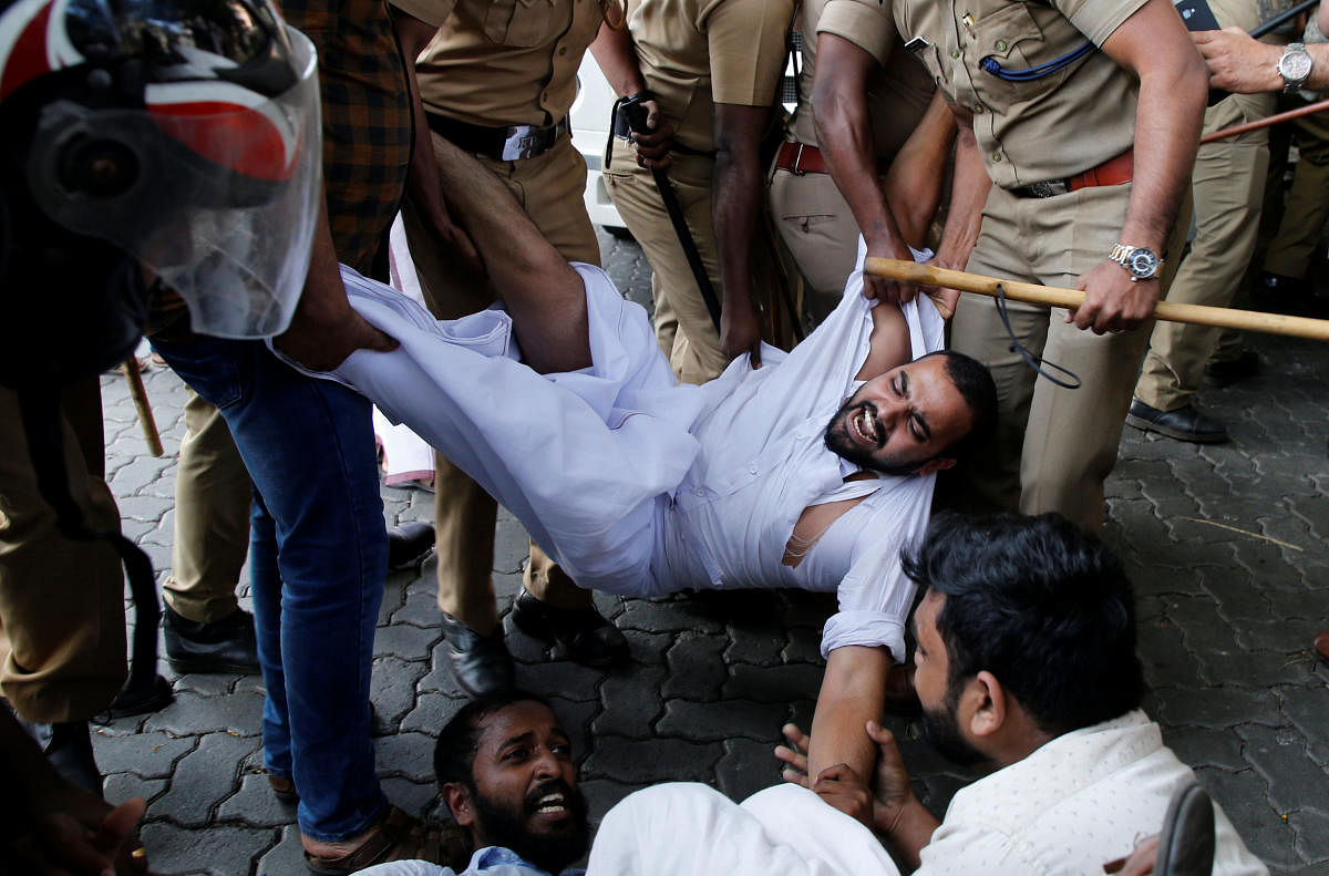 Police remove members of Kerala Students Union, the student wing of India's main opposition Congress party, as they take part in a protest after two women entered the Sabarimala temple, in Kochi, India, January 2, 2019. REUTERS/Sivaram V
