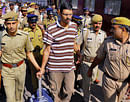 Bitti Mohanty, convicted in the 2006 German woman rape case, at Jaipur railway station on Friday. The Kerala police brought him in Jaipur to produce in a court. PTI Photo