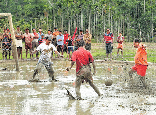 Tourists play mud football during Splash at Wayanad.