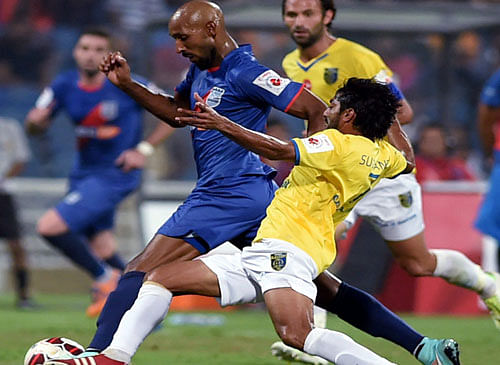 Kerala Blasters FC (yellow) and Mumbai City FC player Nicolas Anelka (blue) vie for the ball during the ISL match in Mumbai on Sunday. PTI Photo