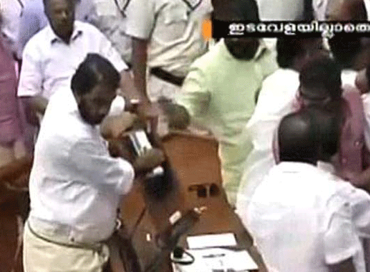 Kerala Assembly today witnessed unprecedented and ugly scenes as opposition members went on a rampage destroying Speaker's podium and indulged in scuffle with the watch-and-ward staff even as Finance Minister K M Mani, facing charges in bar bribery scam, managed to present the state budget.TV grab