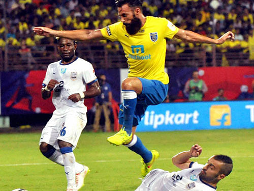 Kerala Blasters FC ( Yellow) and Mumbai FC players in action during the Indian Super League (ISL) Match at Jawaharlal Nehru Stadium in Kochi on Saturday.PTI Photo