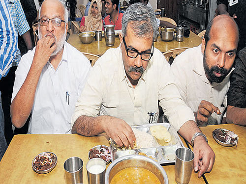 CPM MP Nilotpal Basu and SFI&#8200;president V Sivadasan eat beef at Kerala House in New Delhi on Wednesday. Chaman Gautam