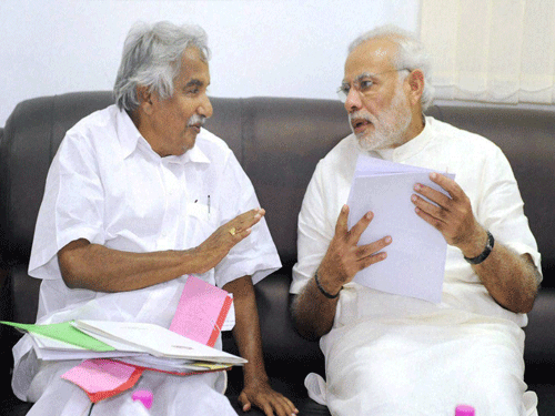 Prime Minister Narendra Modi in a meeting with Chief Minister of Kerala, Oommen Chandy in Kerala on Tuesday. PTI Photo.