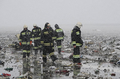 Russian Emergency Ministry employees are seen in the snow among the wreckage of a crashed plane at the Rostov-on-Don airport, about 950 kilometers (600 miles) south of Moscow, Russia Saturday, March 19, 2016. A Dubai airliner crashed and caught fire early Saturday while landing in strong winds in the southern Russian city of Rostov-on-Don, officials said. AP/PTI
