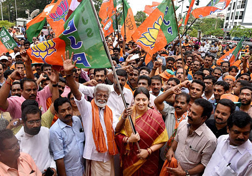Union HRD Minister Smriti Irani flagging off a roadshow campaign of Kerala BJP president and NDA candidate from Vattiyoorkavu Assembly constituency Kummanam Rajasekharan in Thiruvananthapuram on Saturday. PTI Photo