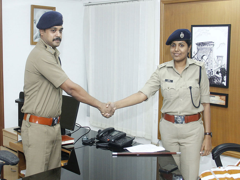 Santeesh and Ajeetha shake hands as part of custom of transferring power.