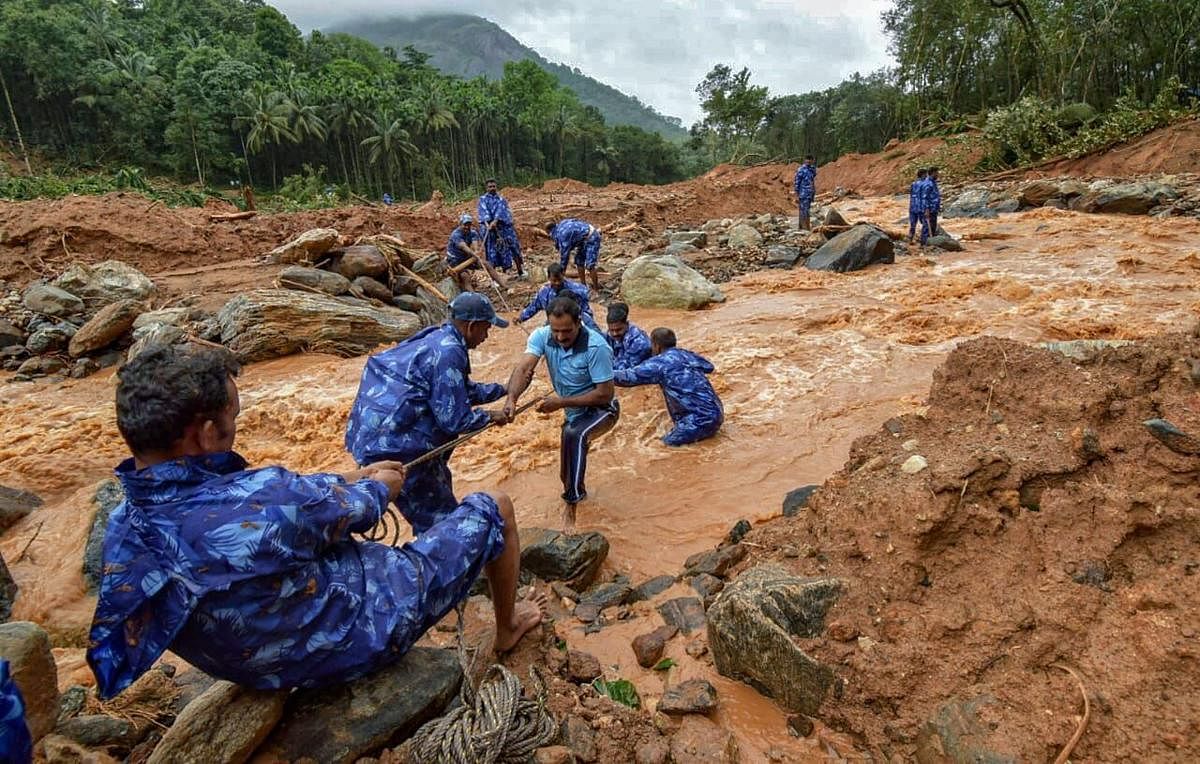 Rescue workers search for the bodies of missing persons after a landslide, triggered by heavy rains and floods, at Nenmara in Palakkad on Friday, Aug 17, 2018. 10 people have reportedly died in the mishap. (PTI Photo)