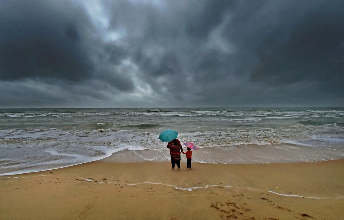 A woman standing with her son at Marina beach. PTI file photo