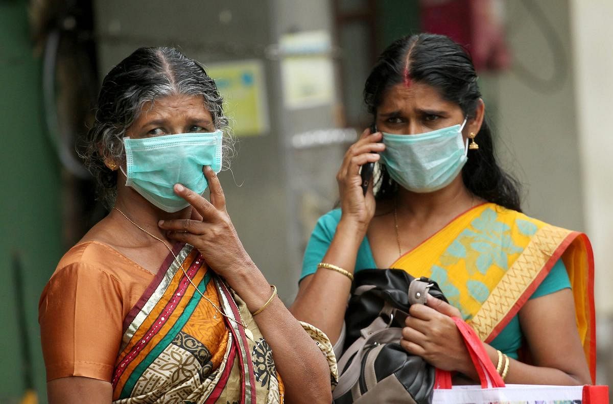 Family members of a patient infected by Nipah virus wear safety masks at the Kozhikode Medical College hospital. pti