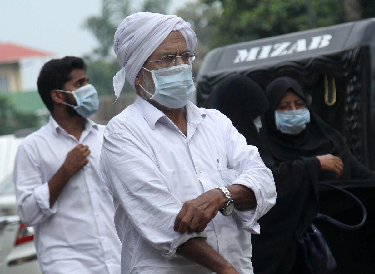 People wear safety masks as a precautionary measure after the 'Nipah' virus outbreak, at Kozhikode Medical College, in Kerala, on Saturday. PTI photo