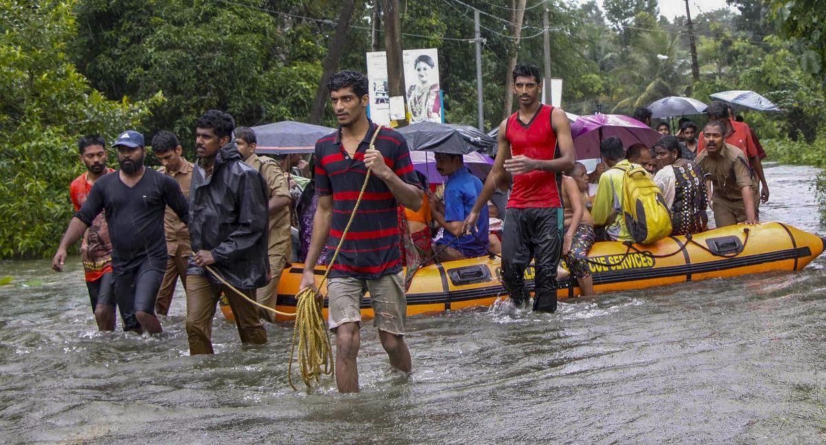 Police personnel and rescue team carry out work after heavy monsoon rain, in Kottayam. PTI file photo