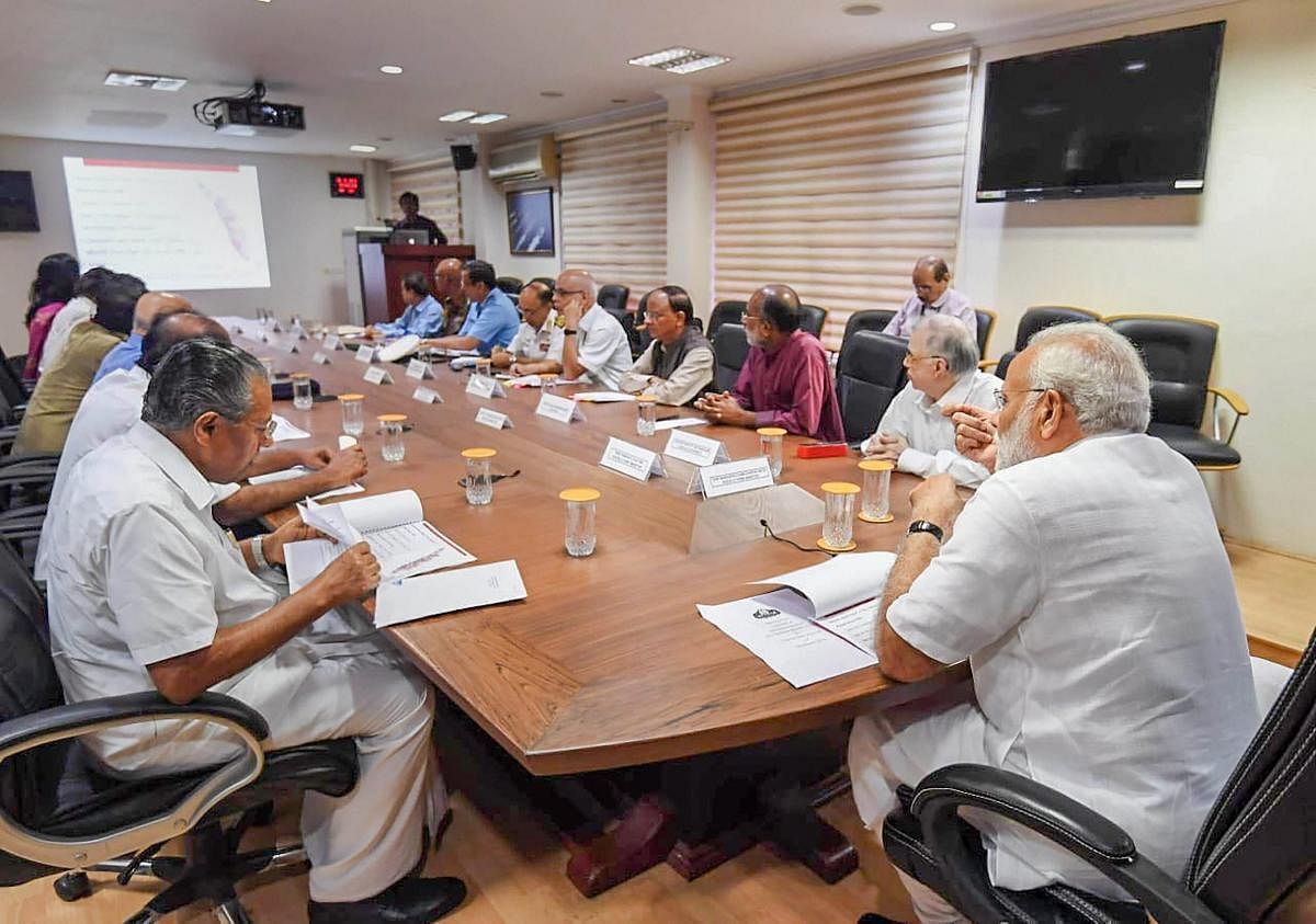 Prime Minister Narendra Modi during a review meeting on his arrival to take stock of the flood situation, in Kochi on Saturday. PTI