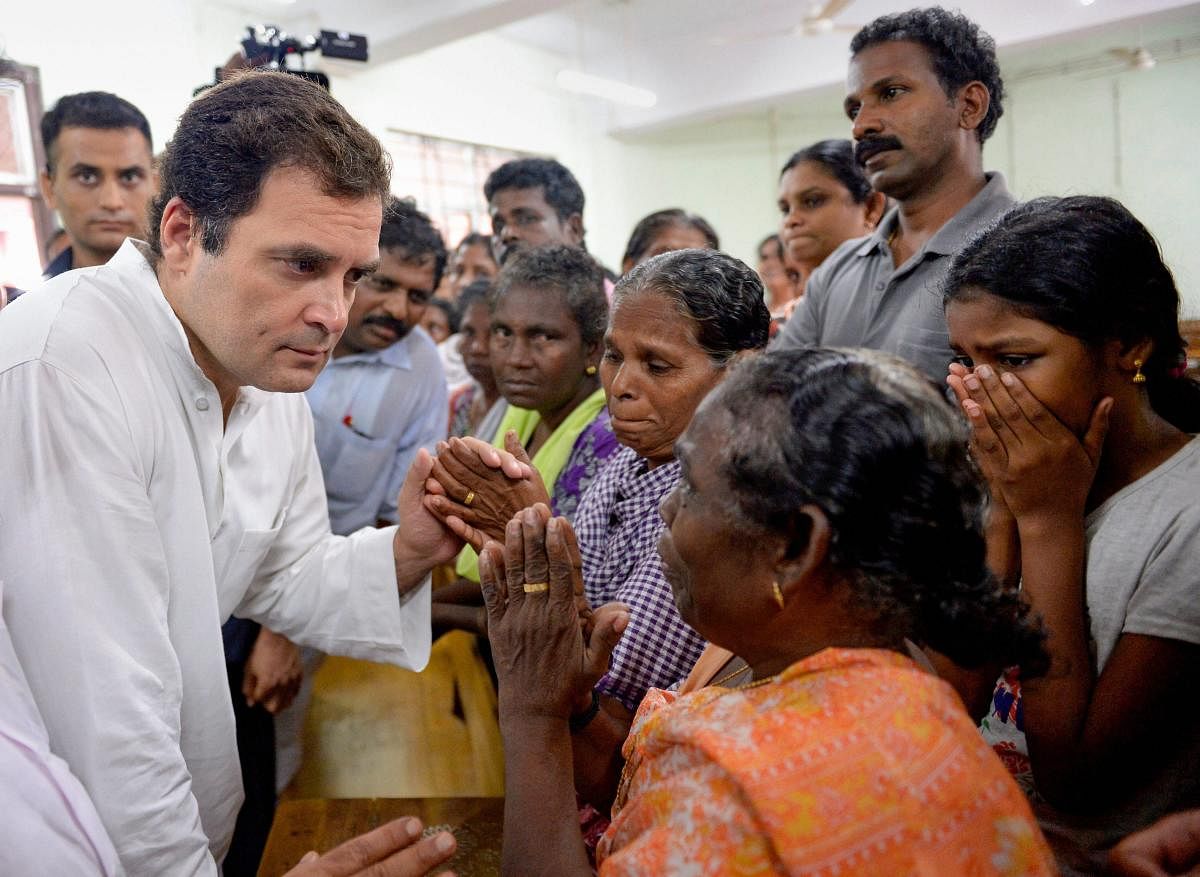 Congress President Rahul Gandhi interacts with the flood-affected people at a relief camp in Chengannur, Alapuzha, Kerala on Tuesday, August 28, 2018. (PTI Photo)