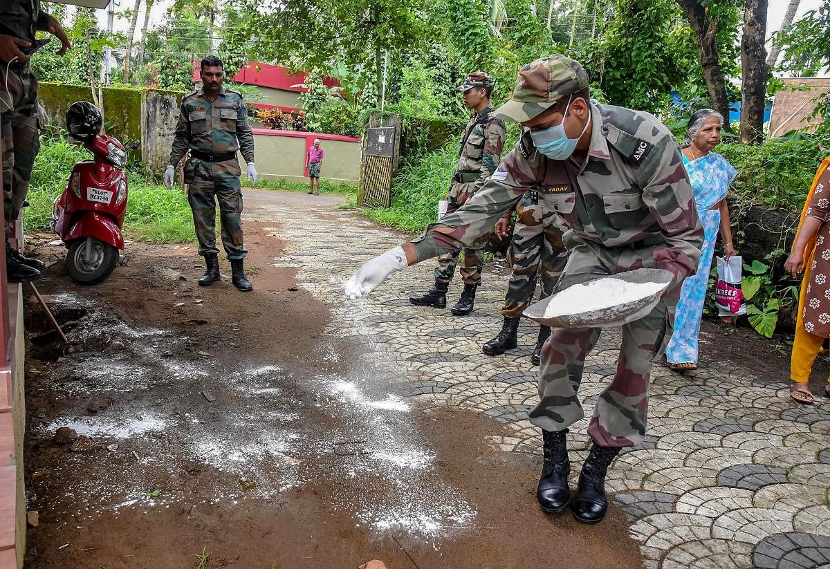 Military Medical Services personnel sanitize a flood-hit school in Kochi. PTI