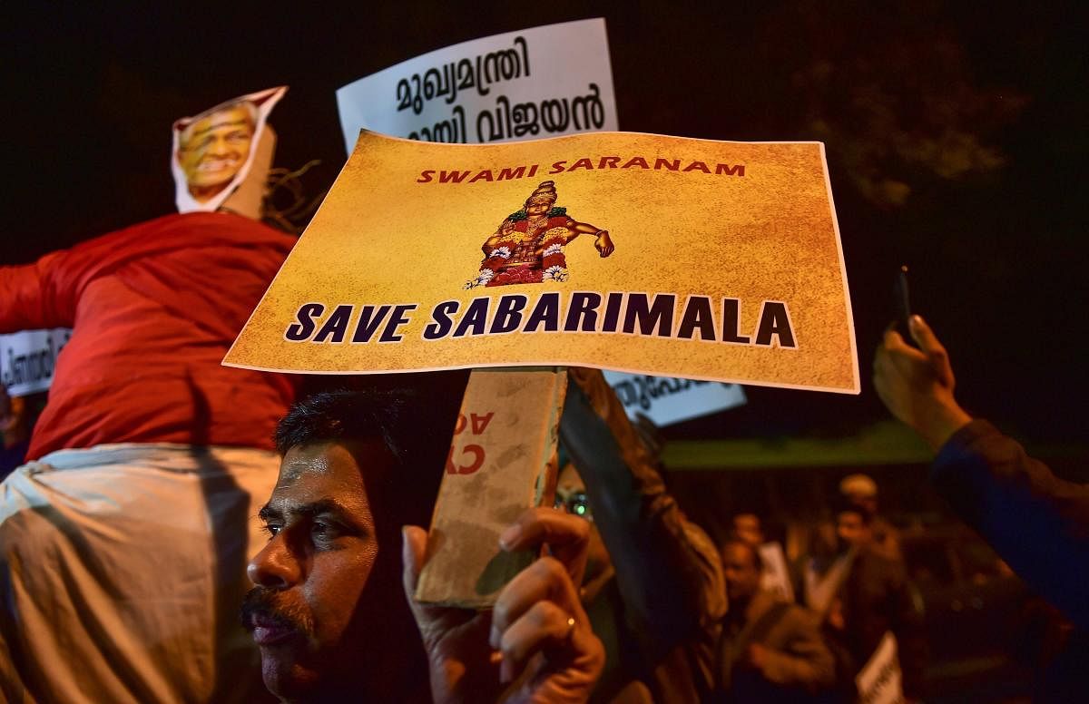 Members of Ayyappa Dharma Samrakshana Samithi (Delhi and NCR) display placards during a protest over the Sabarimala issue, at Kerala House, in New Delhi on Jan 3, 2019. (PTI File Photo)