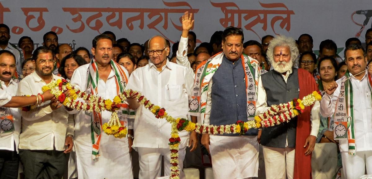 NCP President Sharad Pawar, Congress leader and former Maharashtra chief minister Prithviraj Chavan and other party leaders being garlanded during the Lok Sabha election campaign rally, in Karad on March 24, 2019. PTI