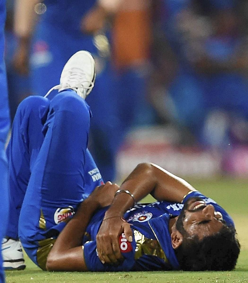 Mumbai Indians Jasprit Bumrah grimaces in pain during an IPL T-20 match against Delhi Capitals in Mumbai Sunday, March 24, 2019. (PTI Photo/Shirish Shete)