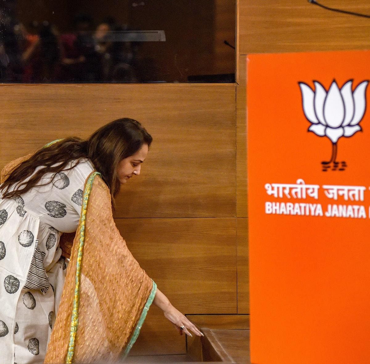 Veteran actor and former MP Jaya Prada touches the floor before stepping on the dais as she arrives to join the BJP in New Delhi on Tuesday. PTI