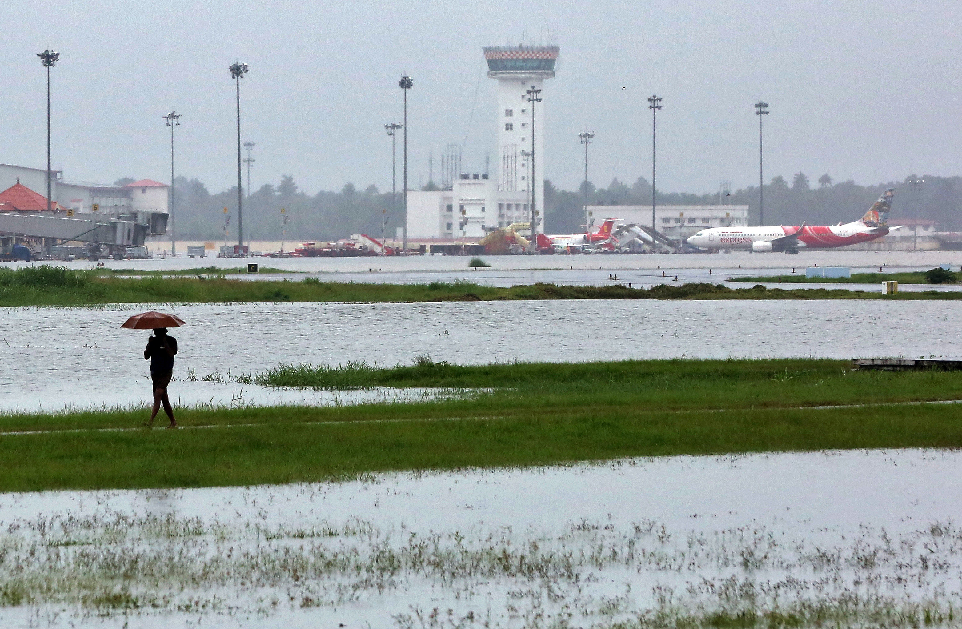 A man walks inside the flooded Cochin international airport after the opening of Idamalayar, Cheruthoni and Mullaperiyar dam shutters following heavy rain, on the outskirts of Kochi. Reuters
