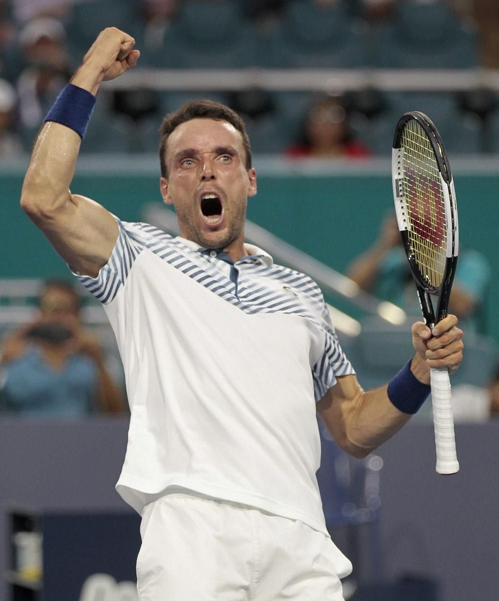 Pumped up: Roberto Bautista Agut celebrates his win over Novak Djokovic during the Miami Open on Tuesday. AFP