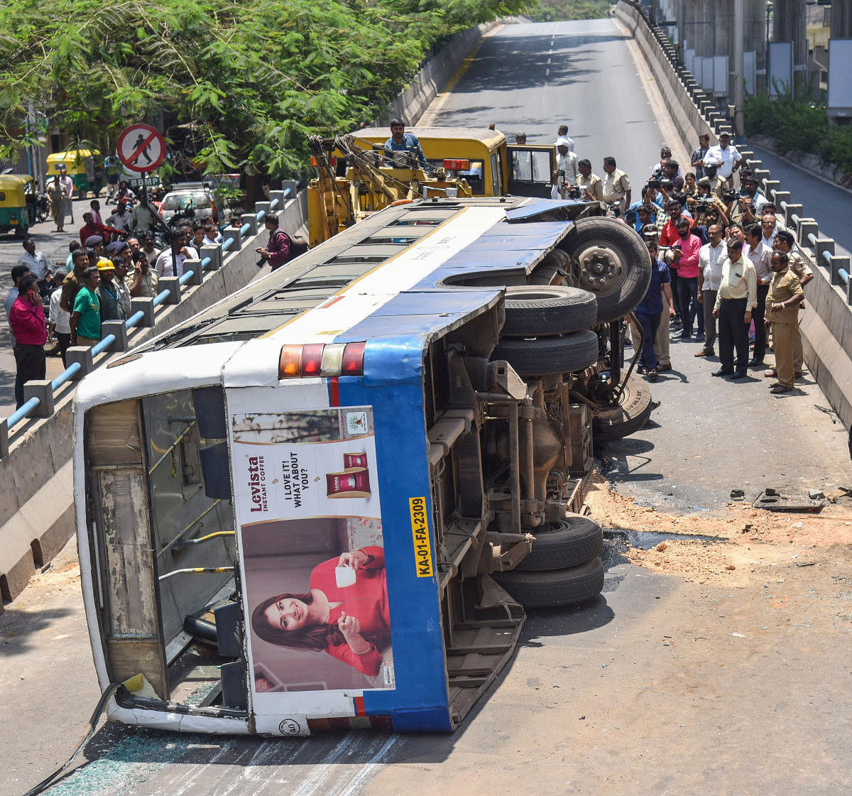 BMTC bus which turned turtle after hitting a divider on west of Chord road in Rajajinagar in Bengaluru on Wednesday. (DH Photo/SK Dinesh)