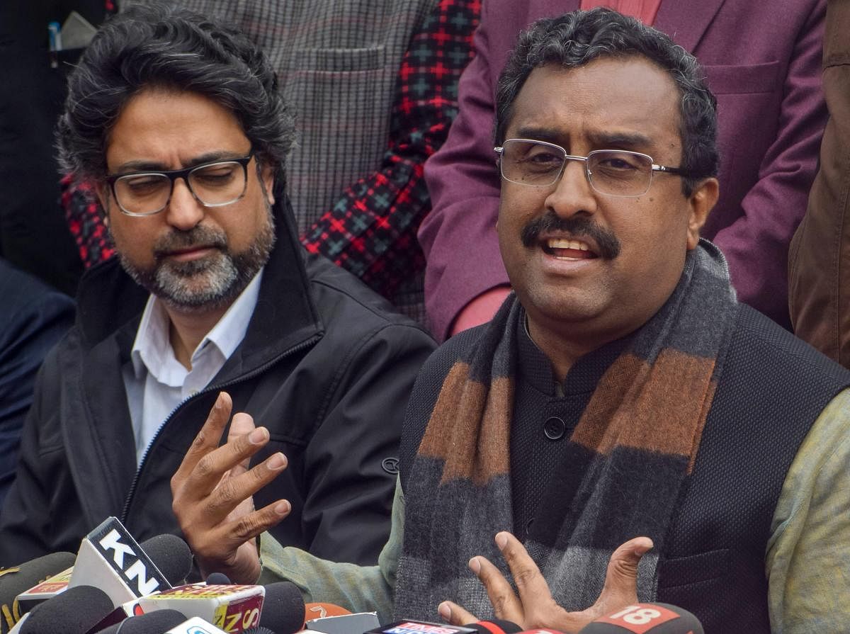 Bhartiya Janta Party (BJP) National General Secretary Ram Madhav speaks, as the party candidate for Srinagar parliamentary constituency Khalid Jehangir looks on, during a press conference, in Srinagar, Wednesday, March 27, 2019. (PTI Photo)