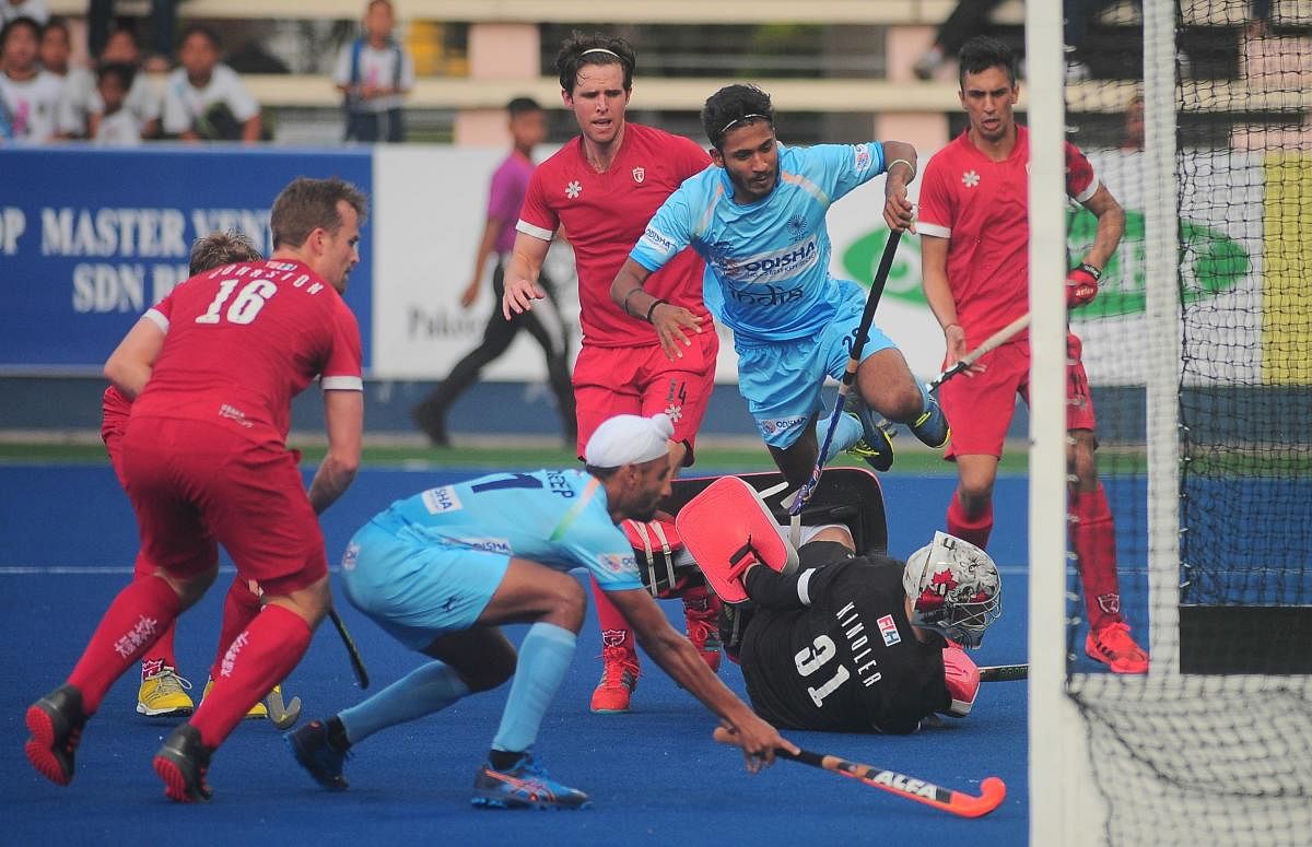 On target India’s Mandeep Singh (left) scores against Canada in the Azlan Shah hockey tournament in Ipoh. HI Media